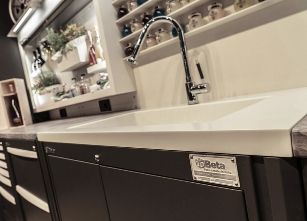Workshop furniture with custom shelving and storage jars above sink featuring 3D Beta brand label