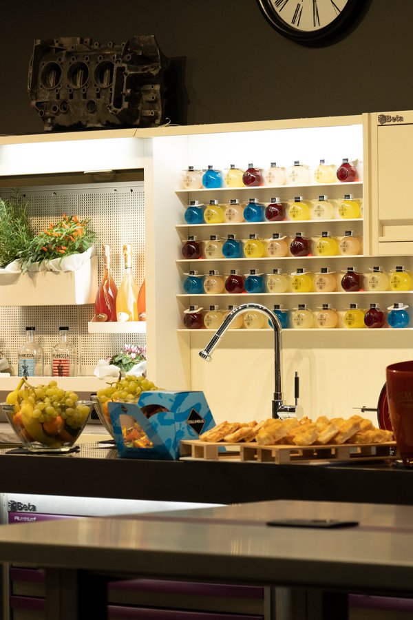Workshop furniture by 3D Beta with a counter arranged like a display of pastries and fruit in a kitchen